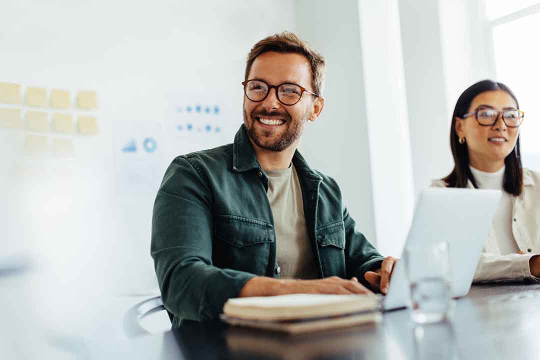 Happy business man listening to a discussion in an office Happy business man listening to a discussion in an office